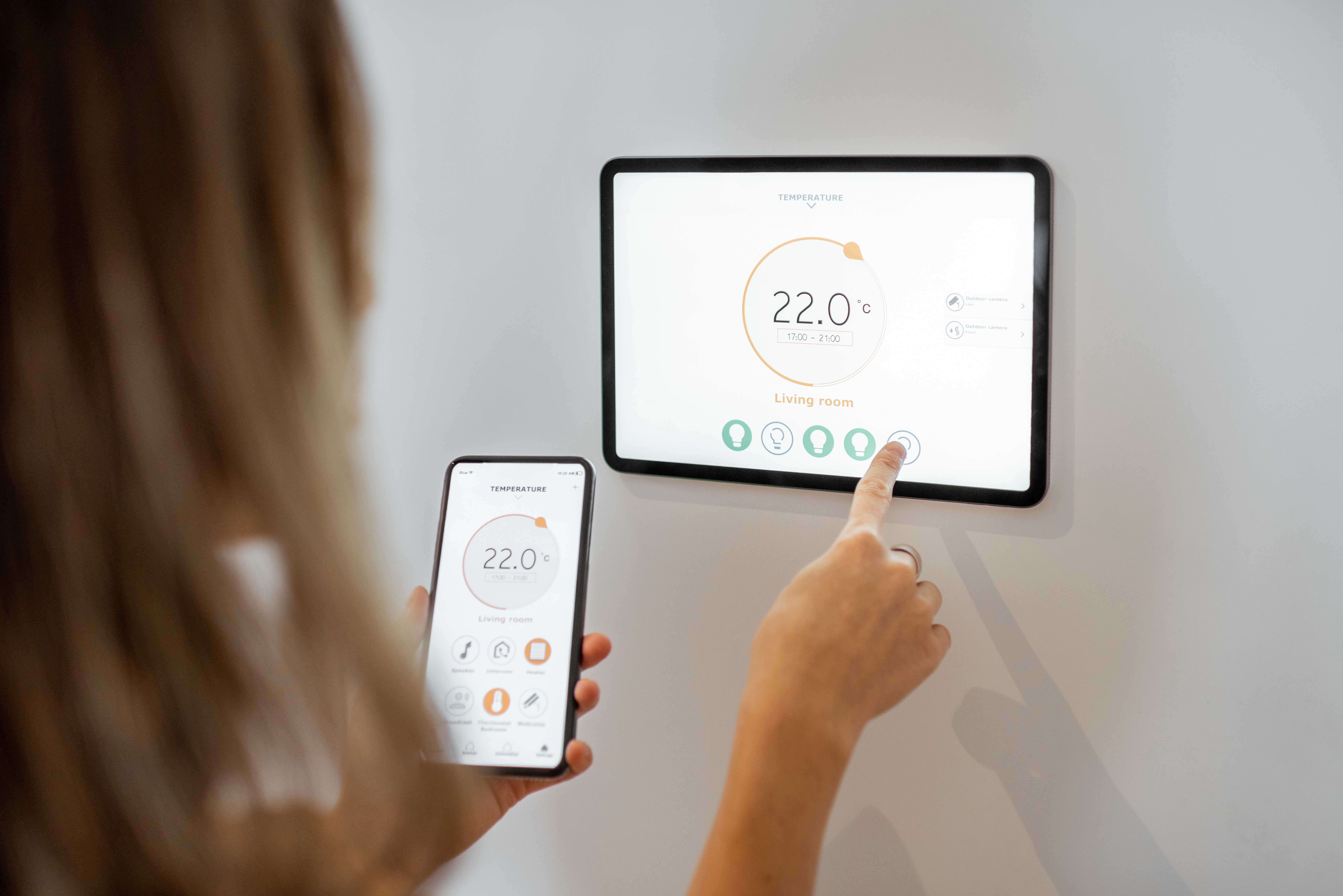 Woman controlling heating with a smart devices